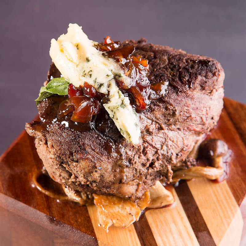 Chateaubriand with Sautéed Royal Trumpet and Beech Mushrooms, Bacon Jam, and Blue Cheese