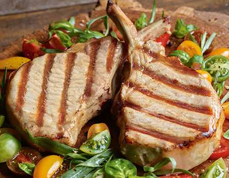 Grilled Berkshire Pork Chops with White Cheddar Polenta and Blueberry Compote